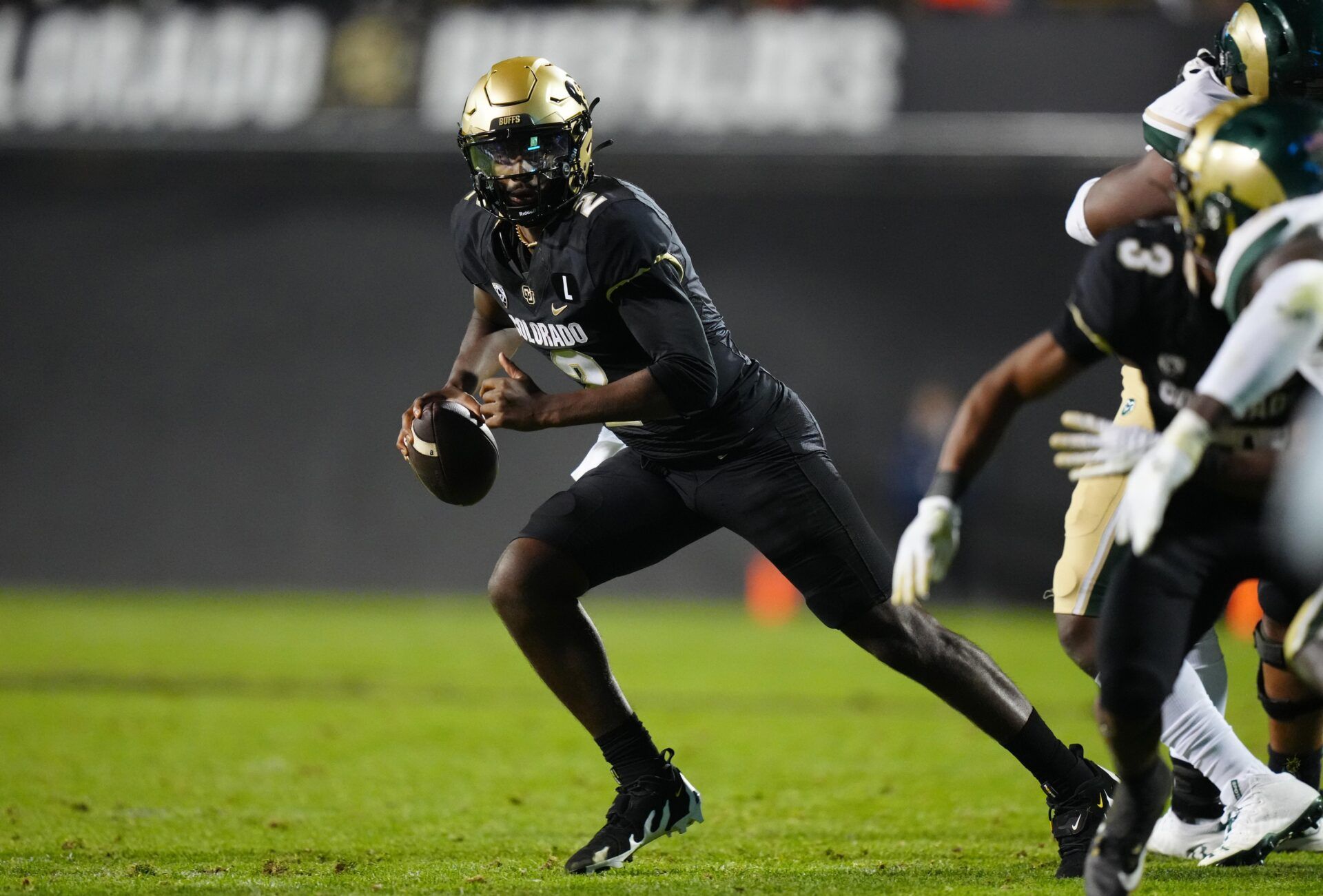 Shedeur Sanders (2) scrambles in double overtime against the Colorado State Rams at Folsom Field.