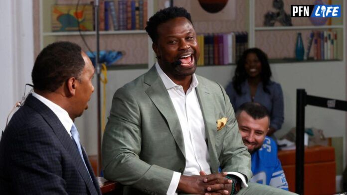 Stephen A. Smith of the ESPN show First Take looks on as Bart Scott, a former Southeastern High School and NFL player, laughs at one of his points during their live broadcast from WGPR-TV broadcast museum in Detroit.