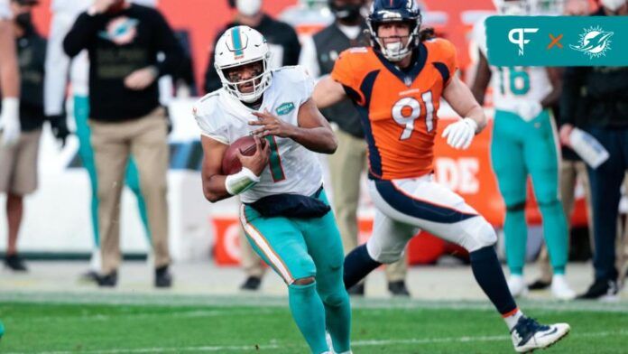 Tua Tagovailoa (1) runs the ball in the third quarter against the Denver Broncos at Empower Field at Mile High.