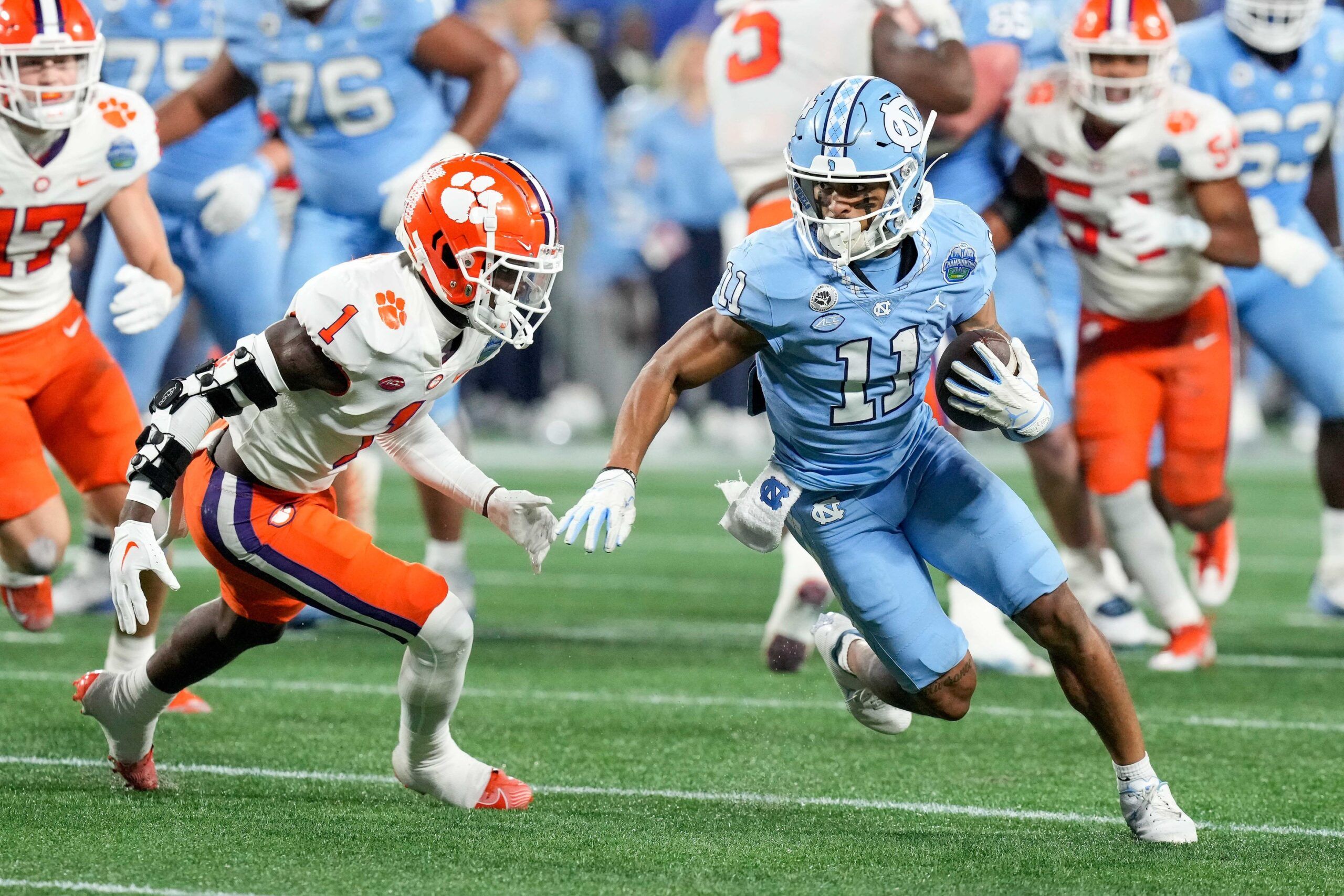 North Carolina Tar Heels wide receiver Josh Downs (11) and Clemson Tigers safety Andrew Mukuba (1) at Bank of America Stadium.