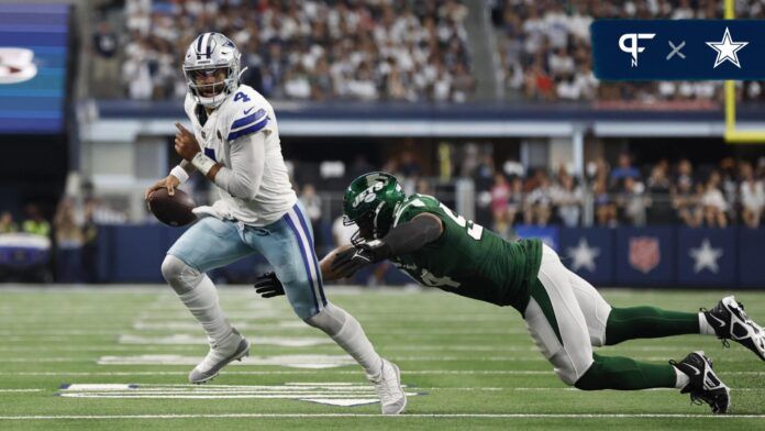 Dallas Cowboys QB Dak Prescott (4) tries to escape a tackle against the New York Jets.