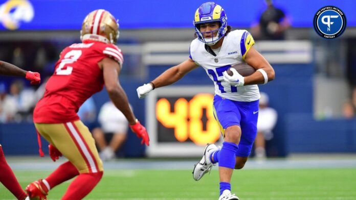 Puka Nacua (17) runs the ball against San Francisco 49ers cornerback Deommodore Lenoir (2) during the first half at SoFi Stadium.