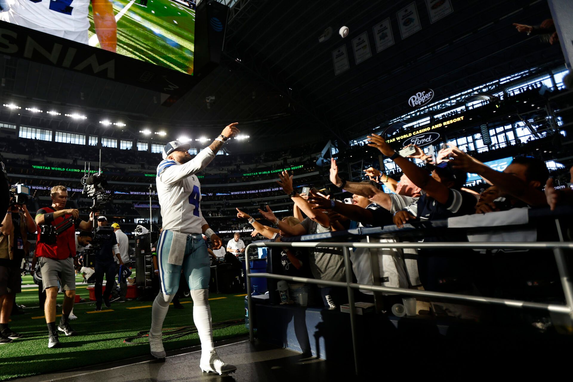 Dallas Cowboys quarterback Dak Prescott (4) throws a sweatband into the crowd after the game against the New York Jets at AT&T Stadium.