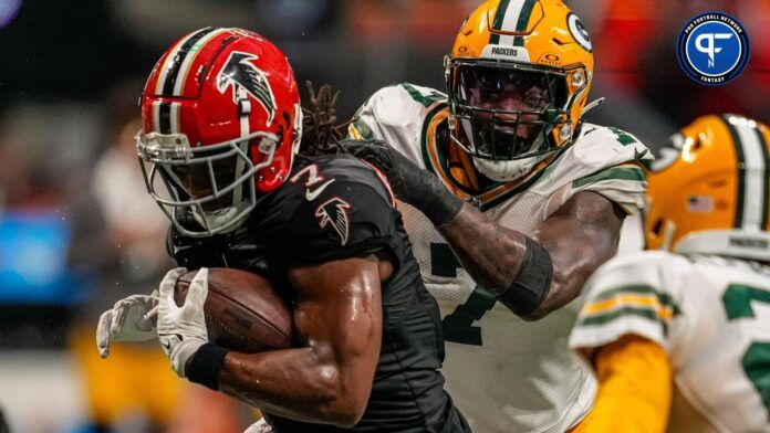 Green Bay Packers linebacker Quay Walker (7) tackles Atlanta Falcons running back Bijan Robinson (7) from behind during the second half at Mercedes-Benz Stadium.