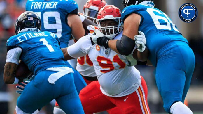 Kansas City Chiefs defensive tackle Derrick Nnadi (91) tries to stop Jacksonville Jaguars running back Travis Etienne Jr. (1) as guard Brandon Scherff (68) pressures during the first quarter of a NFL football game Sunday, Sept. 17, 2023 at EverBank Stadium