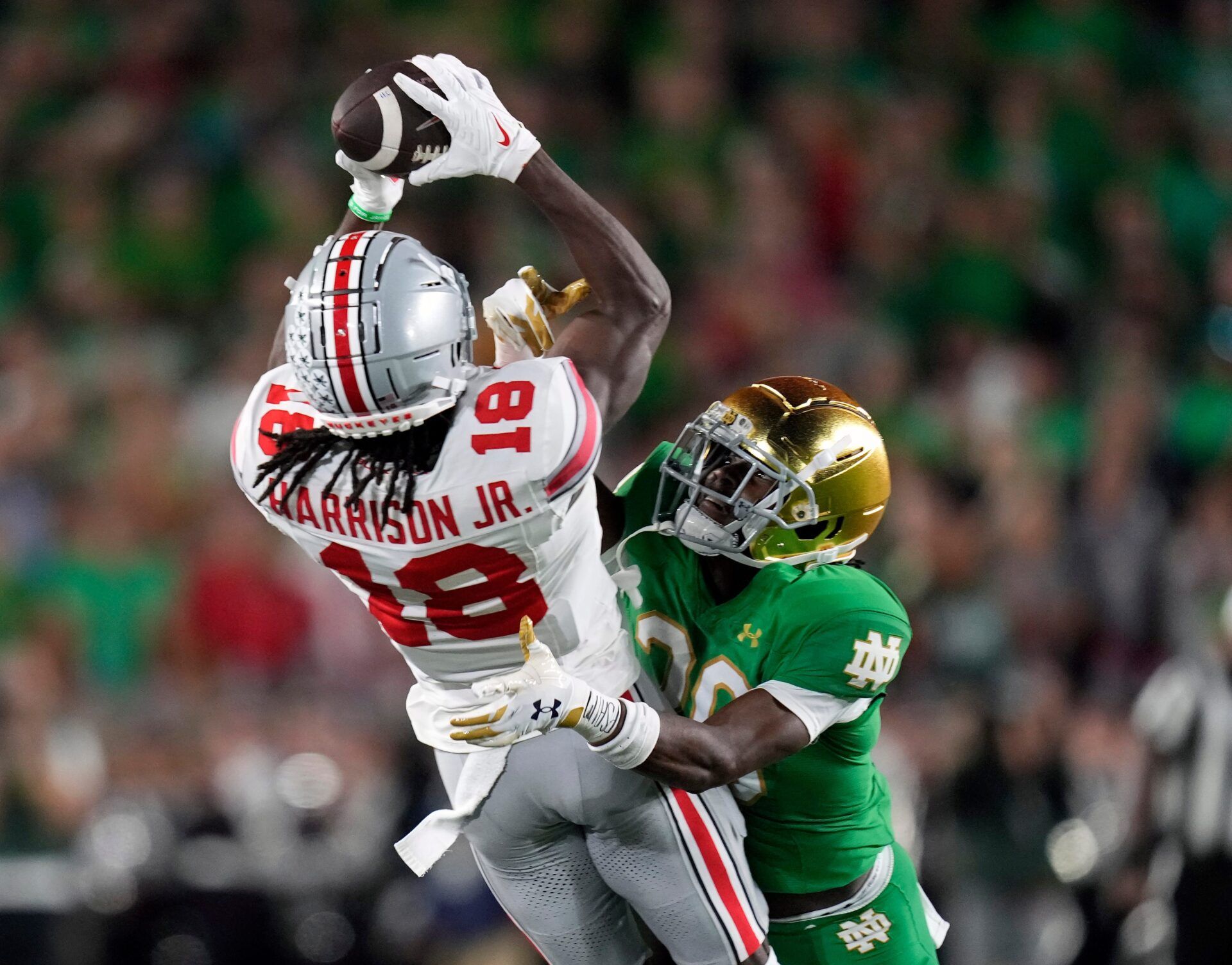 Sep 23, 2023; South Bend, Indiana, USA; Ohio State Buckeyes wide receiver Marvin Harrison Jr. (18) tries to come up with the catch against Notre Dame Fighting Irish cornerback Benjamin Morrison (20) but draws a penalty during the second quarter of their game at Notre Dame Stadium.