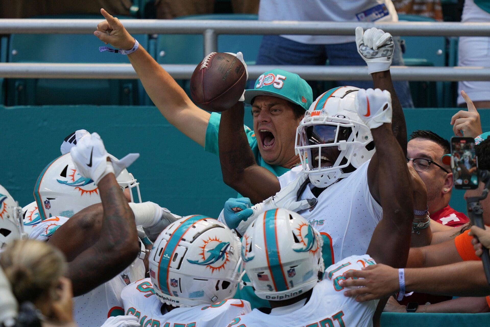 Tyreek Hill (10) celebrates scoring a touchdown against the Denver Broncos during the first half of an NFL game from the stands at Hard Rock Stadium.