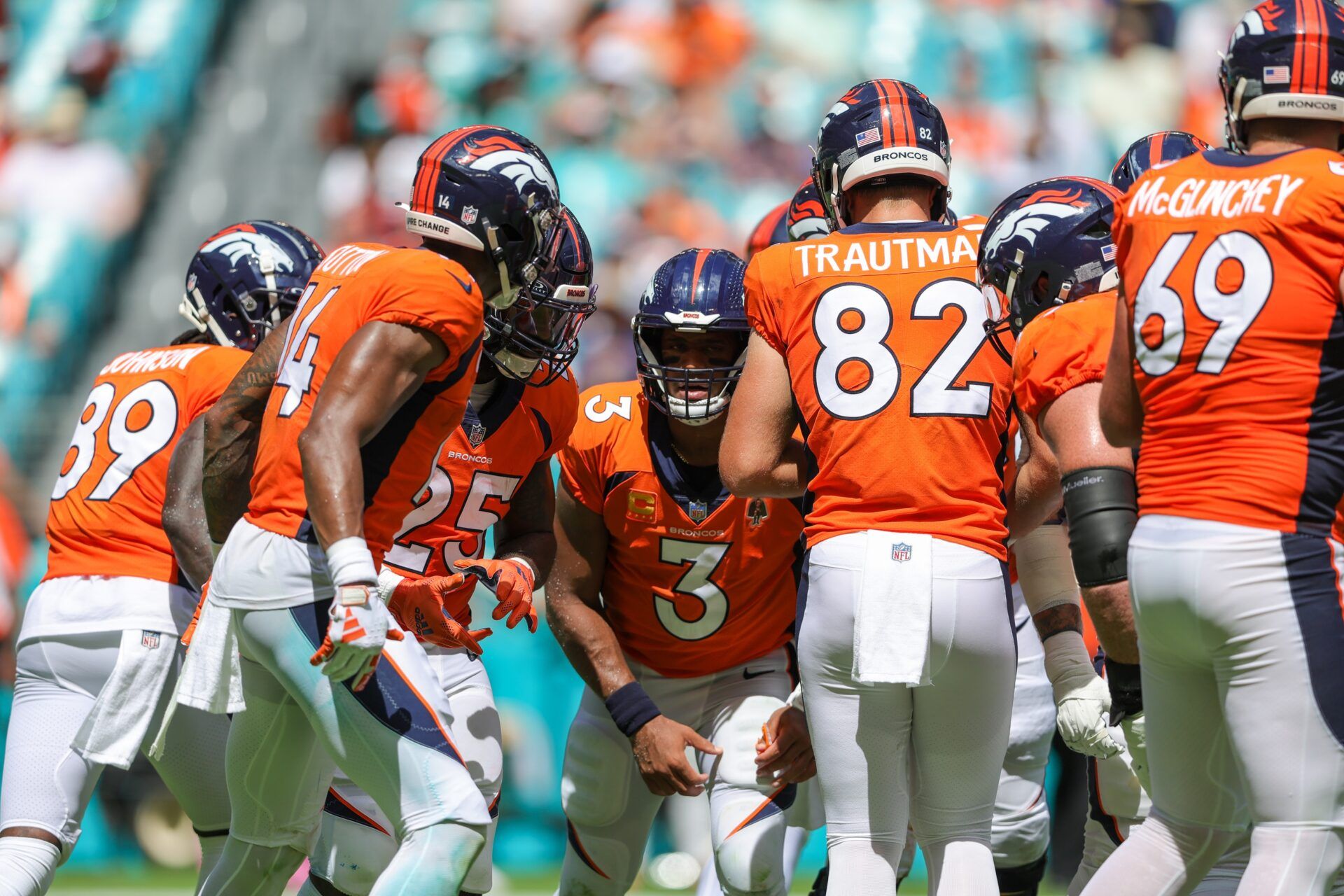 Russell Wilson (3) leads a huddle against the Miami Dolphins in the second quarter at Hard Rock Stadium.