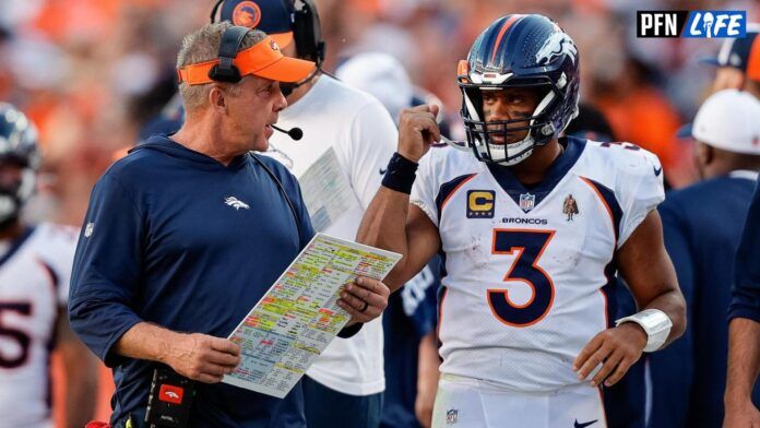 Sean Payton talks with quarterback Russell Wilson (3) in the fourth quarter against the Washington Commanders at Empower Field at Mile High.