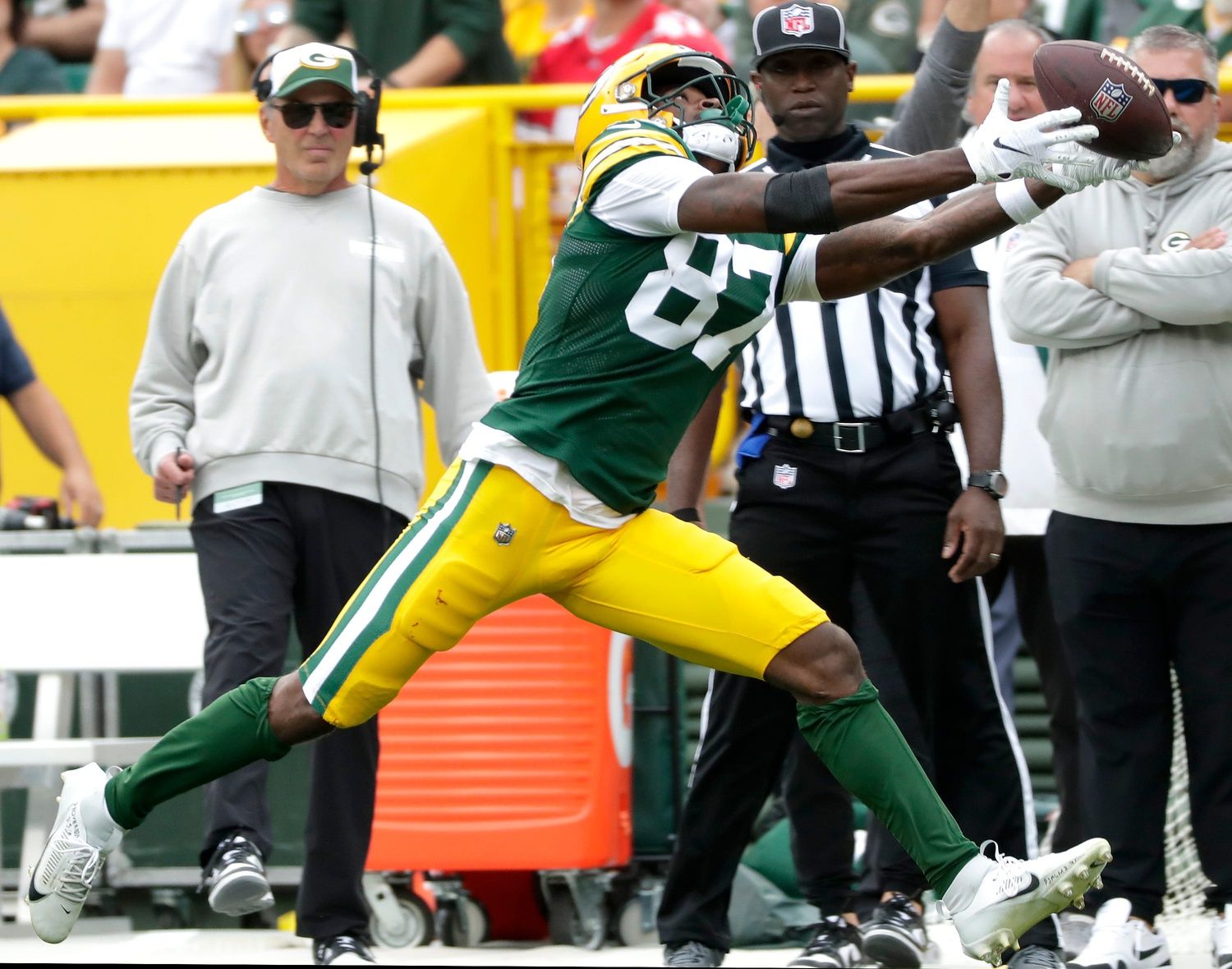 Romeo Doubs (87) stretches for a sideline pass against the New Orleans Saints.