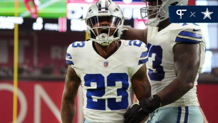 Rico Dowdle (23) celebrates his touchdown against the Arizona Cardinals at State Farm Stadium.