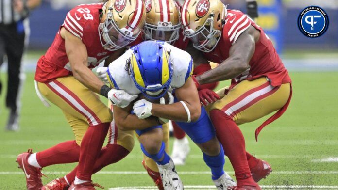 Los Angeles Rams wide receiver Puka Nacua is brought down by three San Francisco 49ers.