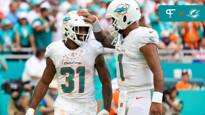 Miami Dolphins RB Raheem Mostert (31) and QB Tua Tagovailoa (1) celebrate after a touchdown against the Denver Broncos.