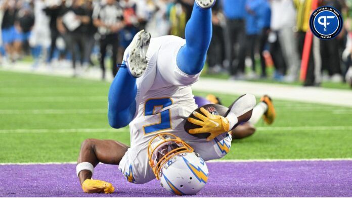 Joshua Palmer (5) catches a touchdown pass from quarterback Justin Herbert (not pictured) off a deflection from Minnesota Vikings cornerback Akayleb Evans (21) during the fourth quarter at U.S. Bank Stadium.