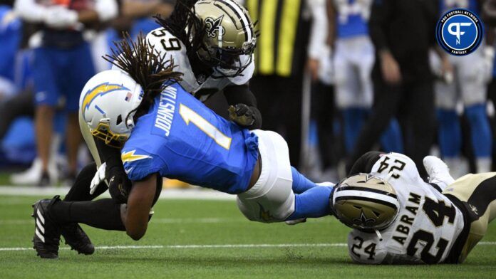 Quentin Johnston (1) is tackled by New Orleans Saints linebacker Jaylon Smith (59) and safety Johnathan Abram (24) during the first half at SoFi Stadium.