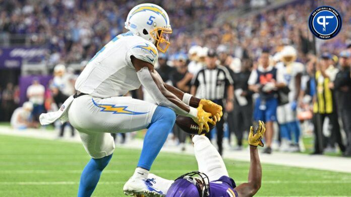 Joshua Palmer (5) catches a touchdown pass from quarterback Justin Herbert (not pictured) off a deflection from Minnesota Vikings cornerback Akayleb Evans (21) during the fourth quarter at U.S. Bank Stadium.