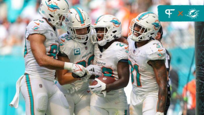 De'Von Achane (28) celebrates his touchdown with Miami Dolphins running back Raheem Mostert (31) against the Denver Broncos in the fourth quarter at Hard Rock Stadium.