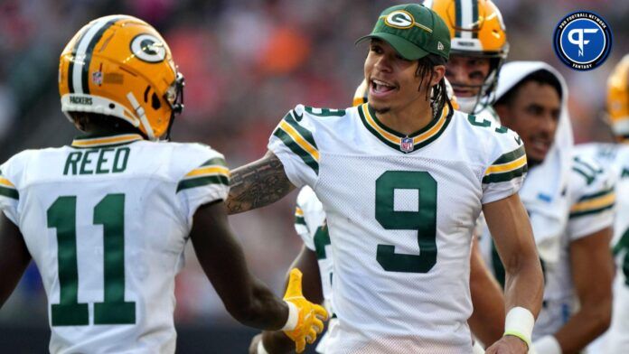 Christian Watson (9) congratulates teammates coming off the field during a Week 1 NFL preseason game.