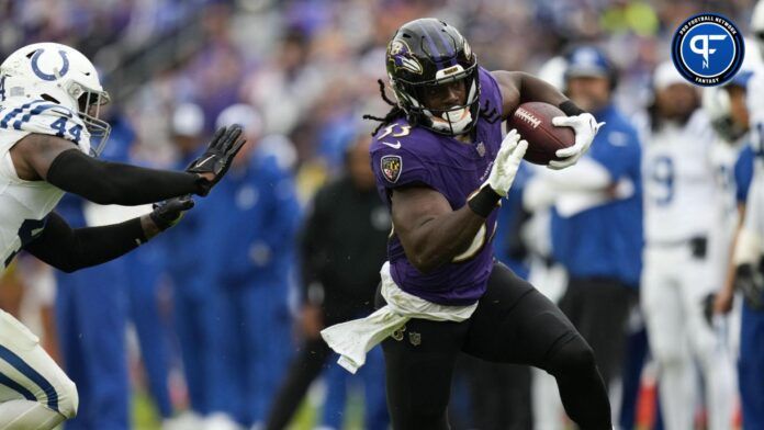 Melvin Gordon III (33) runs with the football while being defended by Indianapolis Colts linebacker Zaire Franklin (44) in the second half at M&T Bank Stadium.