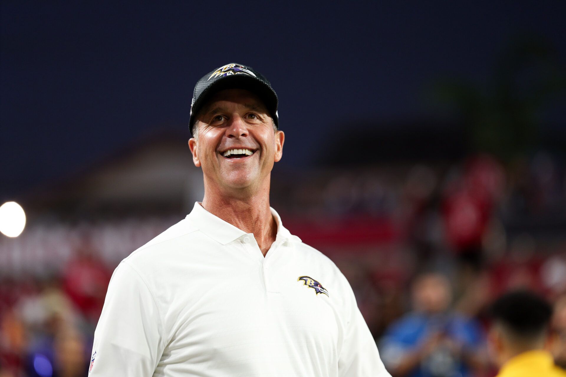 Oct 21, 2024; Tampa, Florida, USA; Baltimore Ravens head coach John Harbaugh walks out onto the field for warm ups before a game against the Tampa Bay Buccaneers at Raymond James Stadium. Mandatory Credit: Nathan Ray Seebeck-Imagn Images