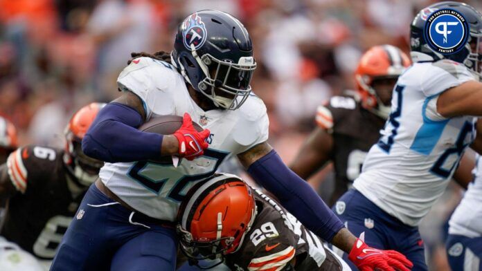 Tennessee Titans running back Derrick Henry (22) evades Cleveland Browns cornerback Cameron Mitchell (29) during the third quarter in Cleveland, Ohio, Sunday, Sept. 24, 2023.