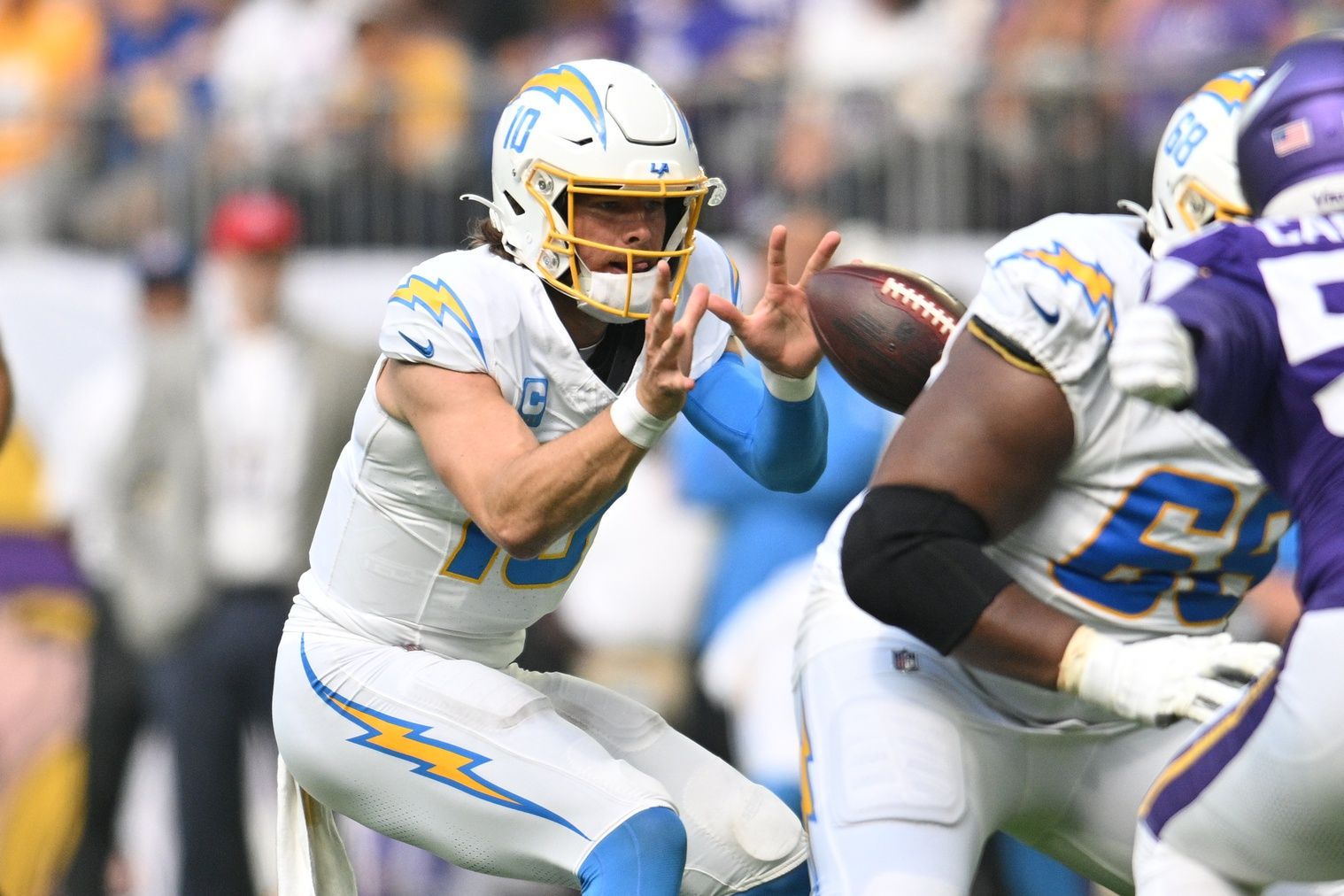 Los Angeles Chargers quarterback Justin Herbert takes a snap against the Minnesota Vikings.