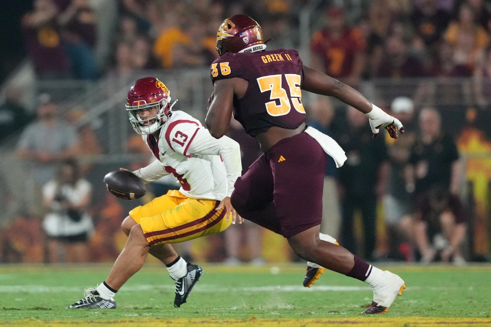 USC Trojans QB Caleb Williams attempts to evade a defender against the Arizona State Sun Devils.