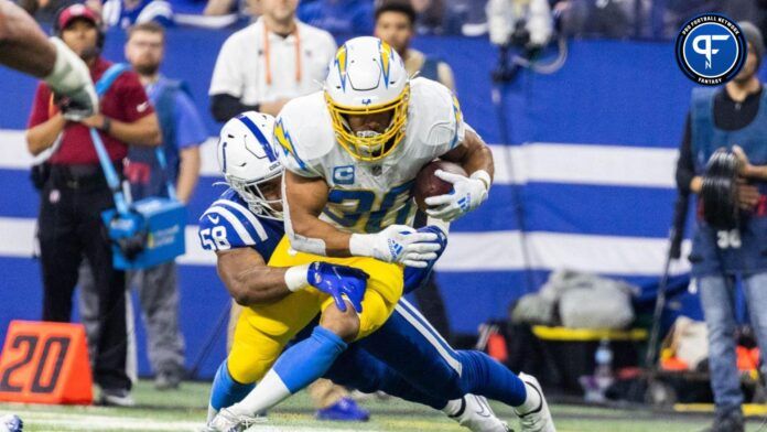 Austin Ekeler (30) runs the ball while Indianapolis Colts linebacker Bobby Okereke (58) defends in the first half at Lucas Oil Stadium.