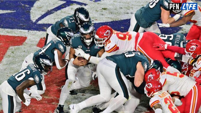 Kansas City Chiefs defensive tackle Chris Jones (95) tackles Philadelphia Eagles quarterback Jalen Hurts (1) on a quarterback sneak during the second quarter of Super Bowl LVII at State Farm Stadium.