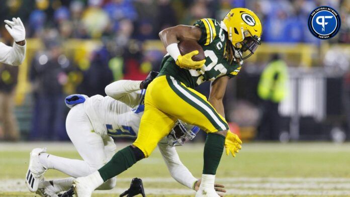 Aaron Jones (33) is tackled with the football during the third quarter against the Detroit Lions at Lambeau Field.