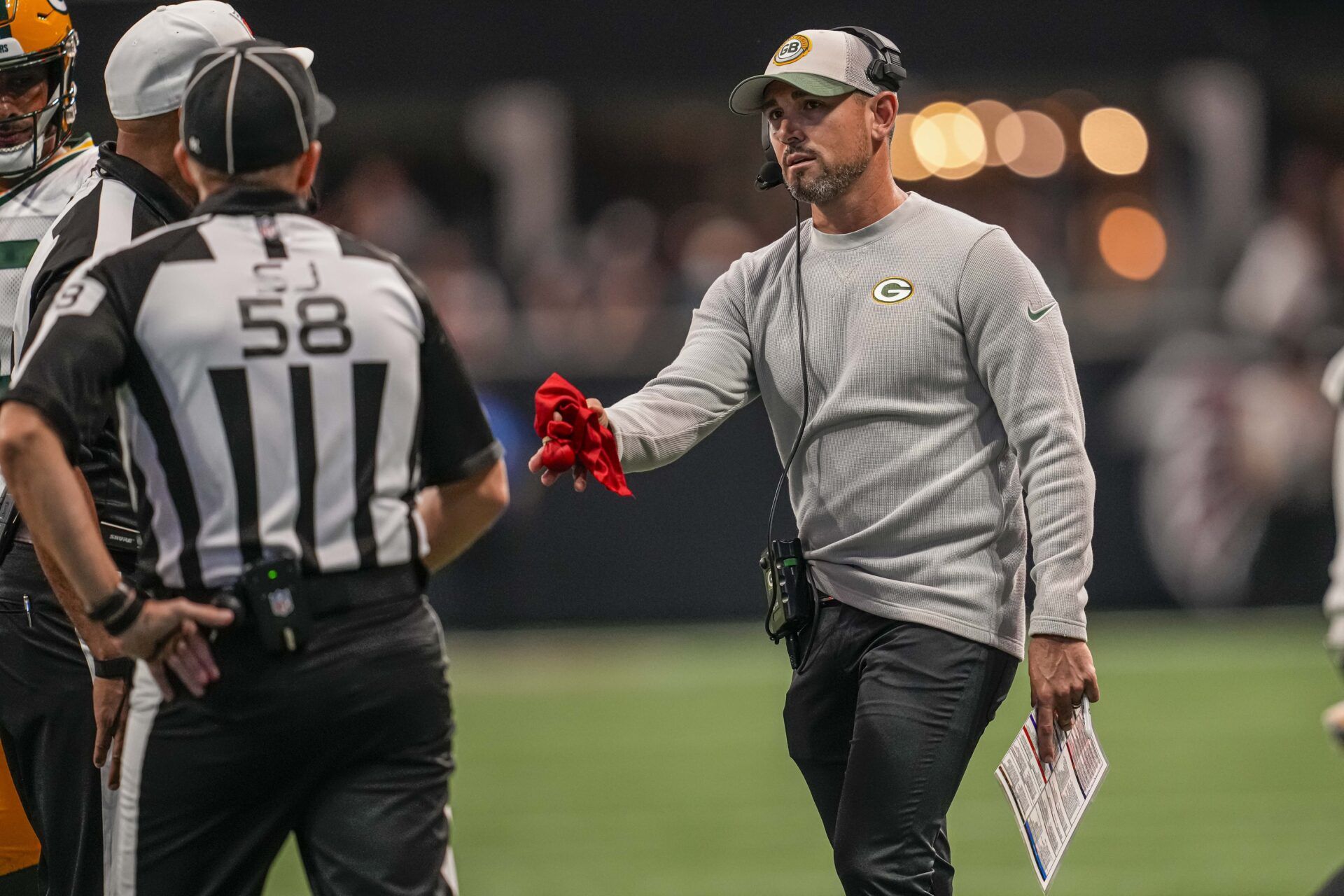 Green Bay Packers head coach Matt LaFleur throws a challenge flag.