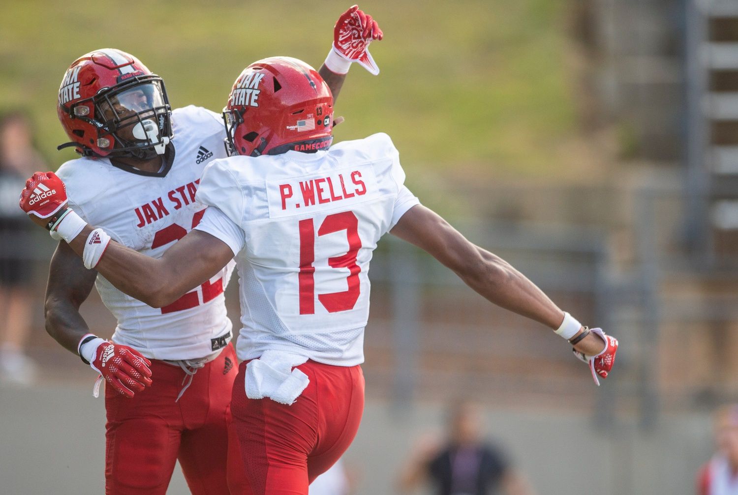 Two Jacksonville State Gamecocks players celebrate a touchdown.