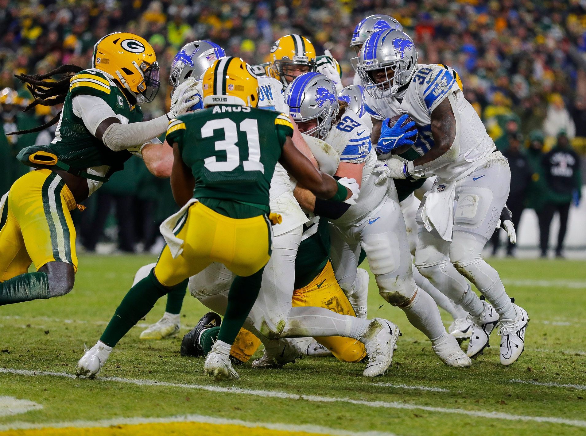 Detroit Lions running back Jamaal Williams (30) scores a touchdown against the Green Bay Packers on Sunday, January 8, 2023, at Lambeau Field in Green Bay, Wis.