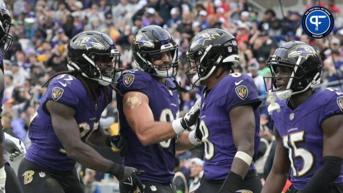 Baltimore Ravens QB Lamar Jackson celebrates with teammates after scoring a TD.