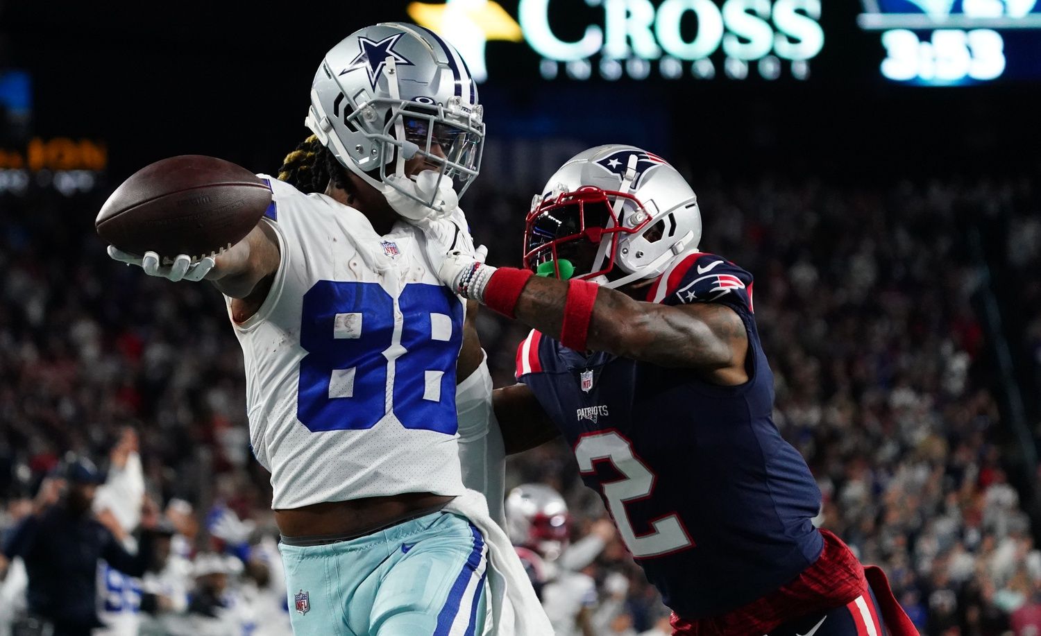 CeeDee Lamb (88) makes the catch and runs the ball for the game winning touchdown against New England Patriots cornerback Jalen Mills (2) in overtime at Gillette Stadium.