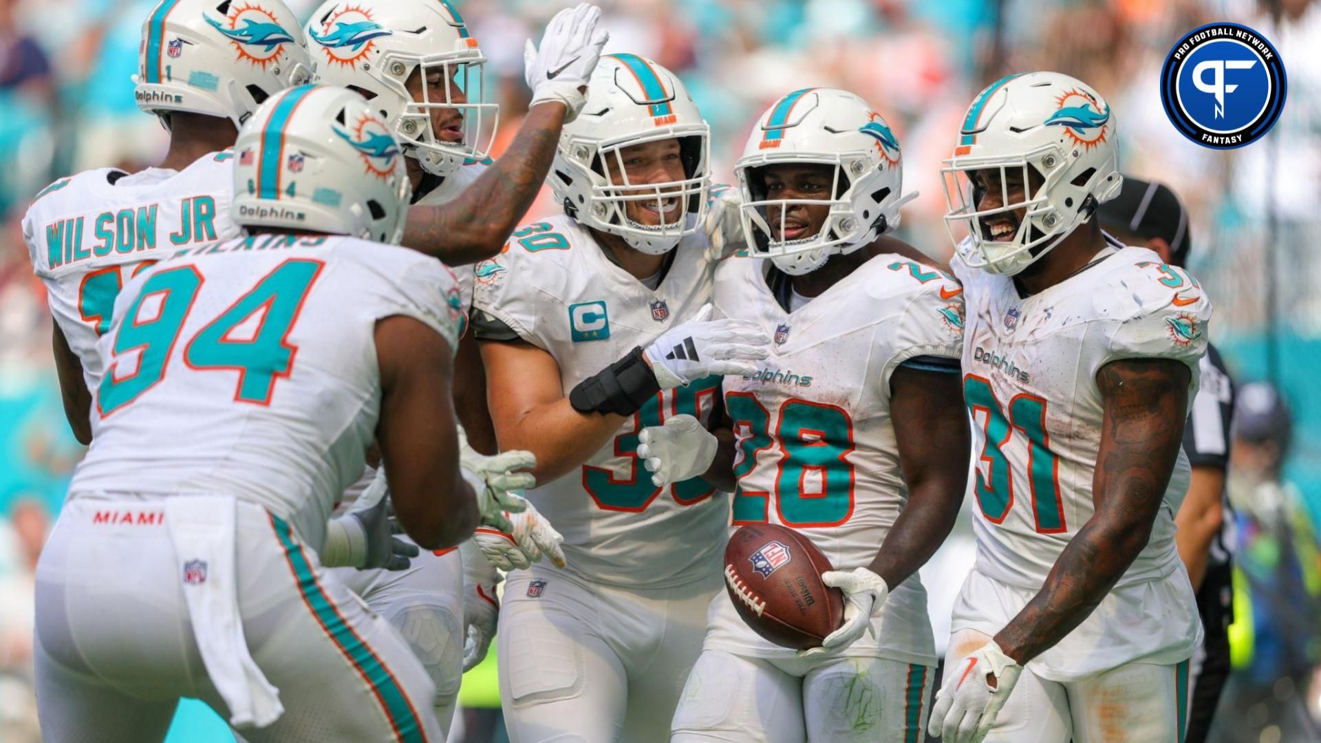 De'Von Achane (28) celebrates his touchdown with Miami Dolphins running back Raheem Mostert (31) against the Denver Broncos in the fourth quarter at Hard Rock Stadium.