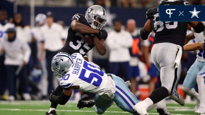 Devin Harper (50) tackles Las Vegas Raiders running back Zamir White (35) in the first quarter at AT&T Stadium.