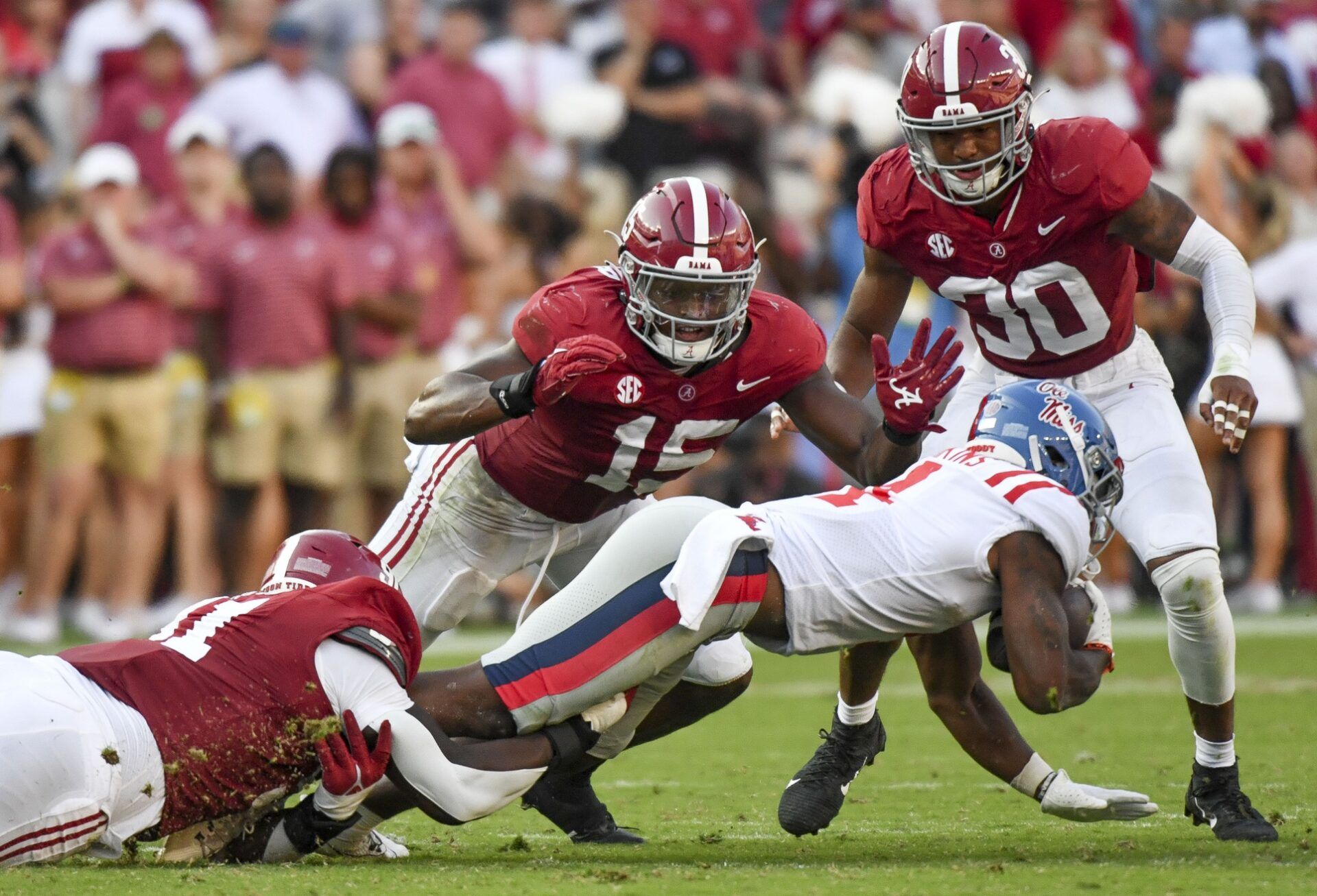 Jaheim Oatis (91) and Alabama Crimson Tide linebacker Dallas Turner (15) combine to bring down Mississippi Rebels running back Quinshon Judkins (4) at Bryant-Denny Stadium. Alabama defeated Mississippi 24-10.