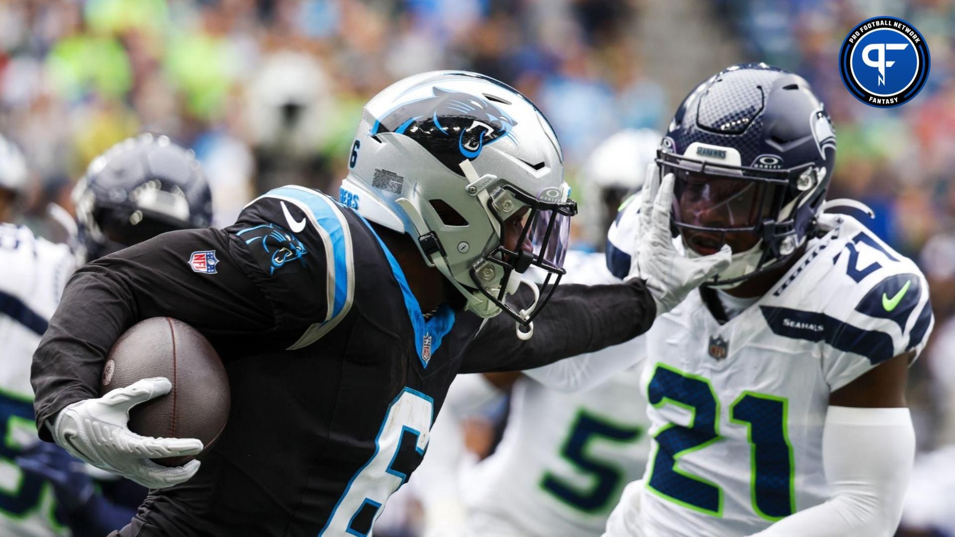 Miles Sanders (6) stiff-arms away from a tackle attempt by Seattle Seahawks cornerback Devon Witherspoon (21) during the second quarter at Lumen Field.