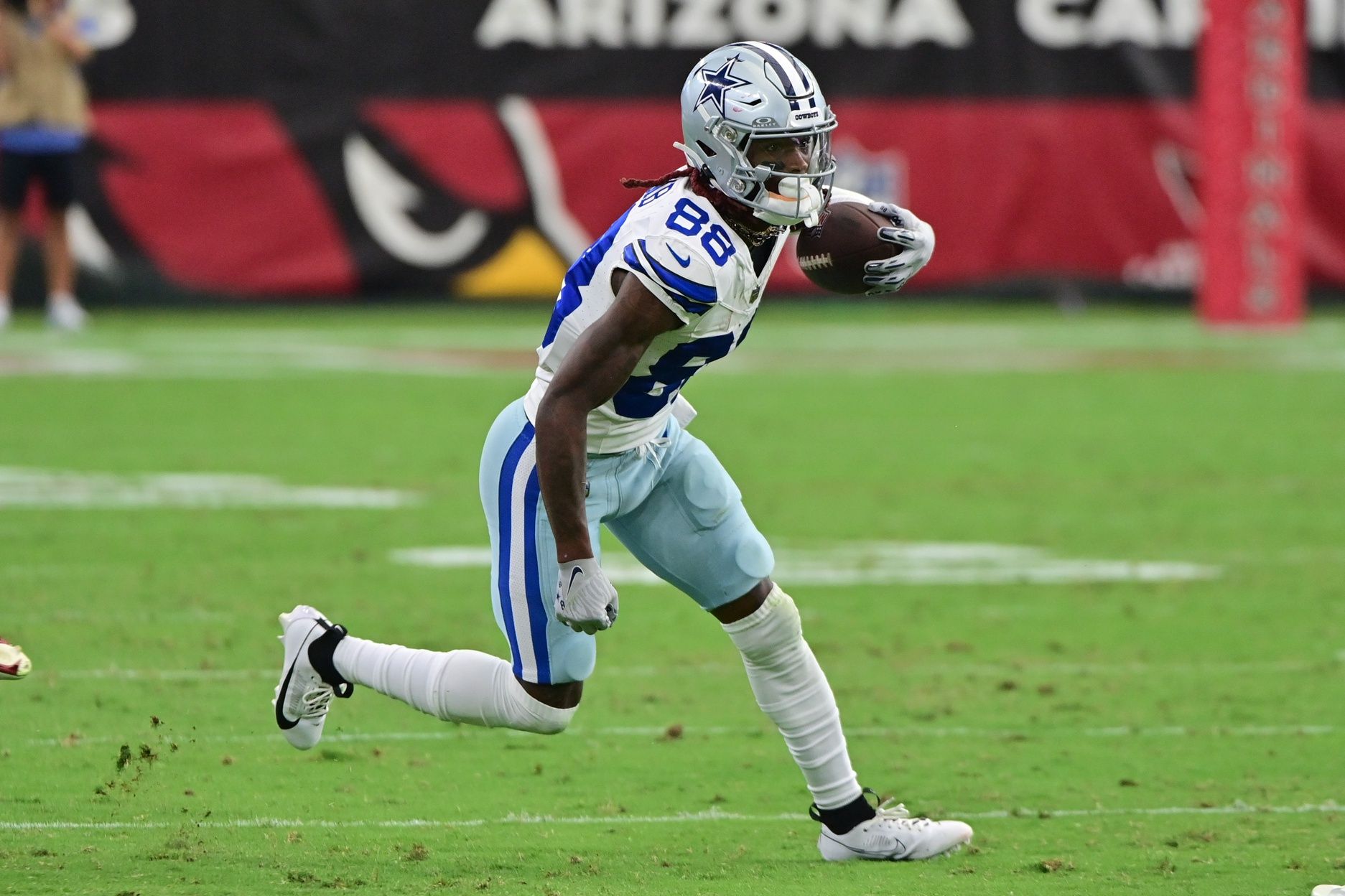 CeeDee Lamb (88) runs the ball in the second half against the Arizona Cardinals at State Farm Stadium.