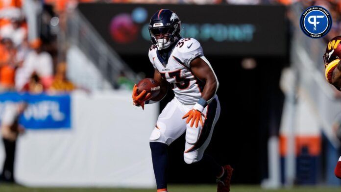 Denver Broncos running back Javonte Williams (33) runs the ball in the second quarter against the Washington Commanders at Empower Field at Mile High.