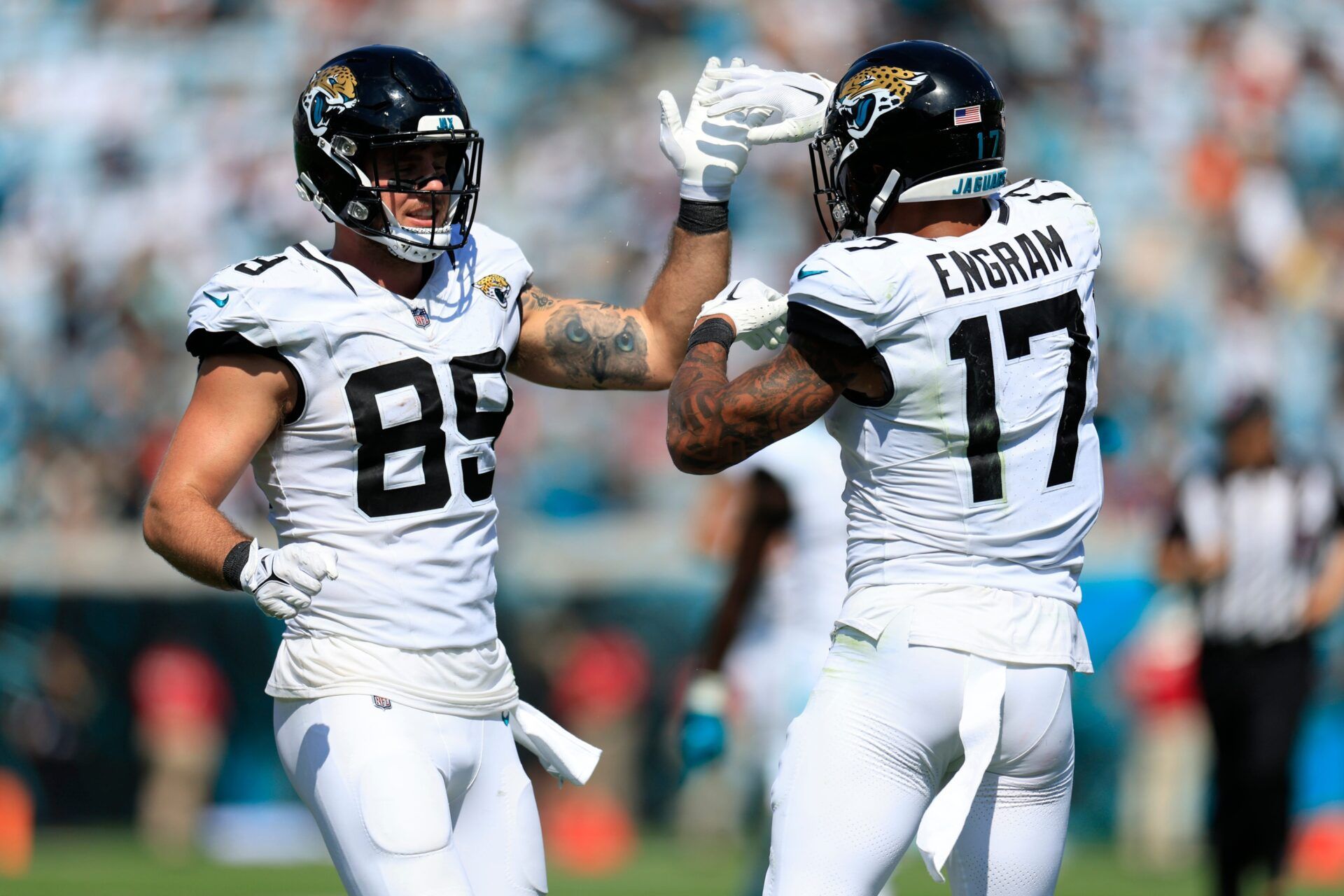 Jacksonville Jaguars TEs Evan Engram and Brenton Strange high five during game.