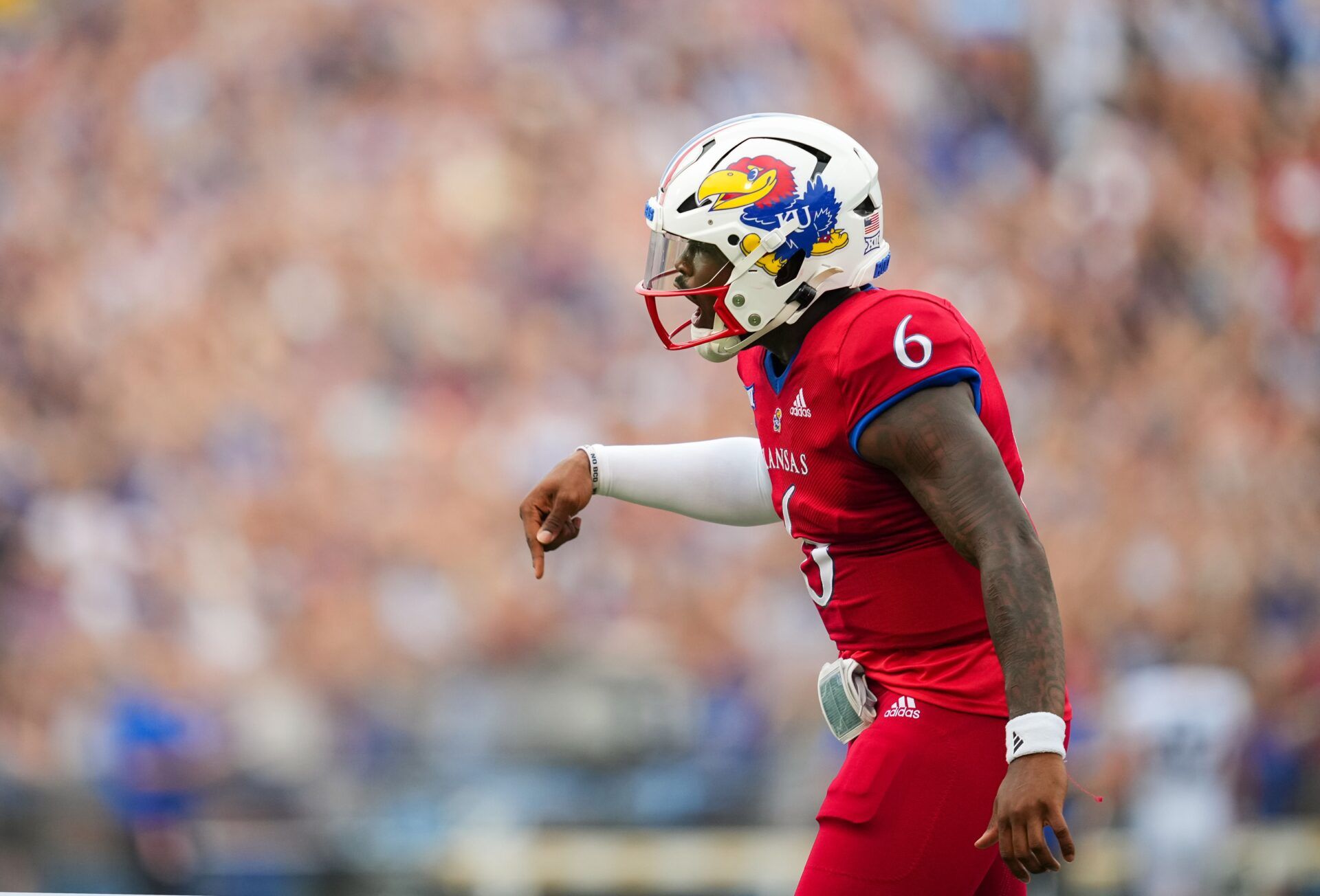 Jalon Daniels (6) celebrates after scoring a touchdown during the first half against the Brigham Young Cougars at David Booth Kansas Memorial Stadium.