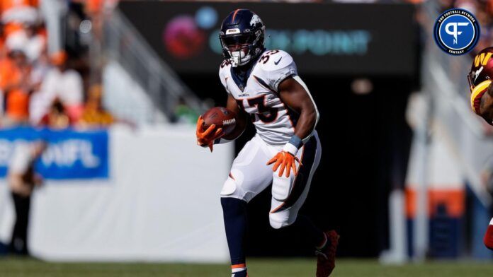 Javonte Williams (33) runs the ball in the second quarter against the Washington Commanders at Empower Field at Mile High.