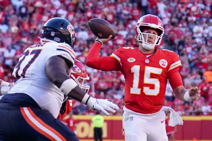 Kansas City Chiefs quarterback Patrick Mahomes (15) throws a pass as Chicago Bears guard Dan Feeney (67) pressures during the second half at GEHA Field at Arrowhead Stadium.