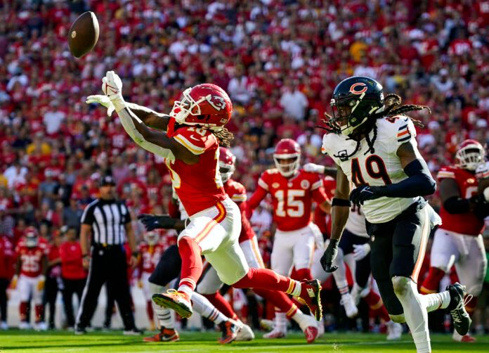 Kansas City Chiefs running back Isiah Pacheco (10) is unable to make the catch against Chicago Bears linebacker Tremaine Edmunds (49) during the first half at GEHA Field at Arrowhead Stadium.