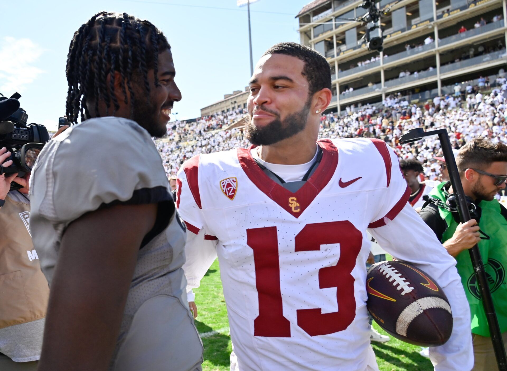 Colorado Buffaloes quarterback Shedeur Sanders (2) meets with USC Trojans quarterback Caleb Williams (13) after the game at Folsom Field.