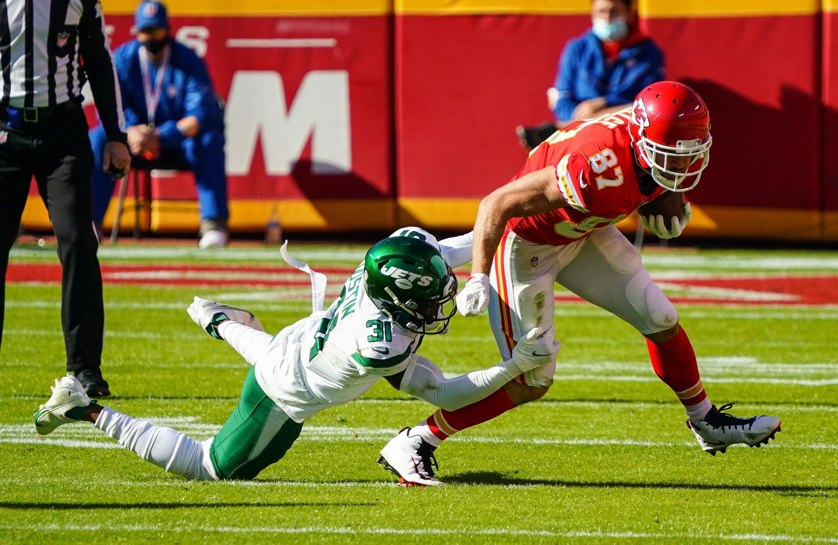 Kansas City Chiefs tight end Travis Kelce (87) is tackled by New York Jets cornerback Quincy Wilson (31) during the second half at Arrowhead Stadium.