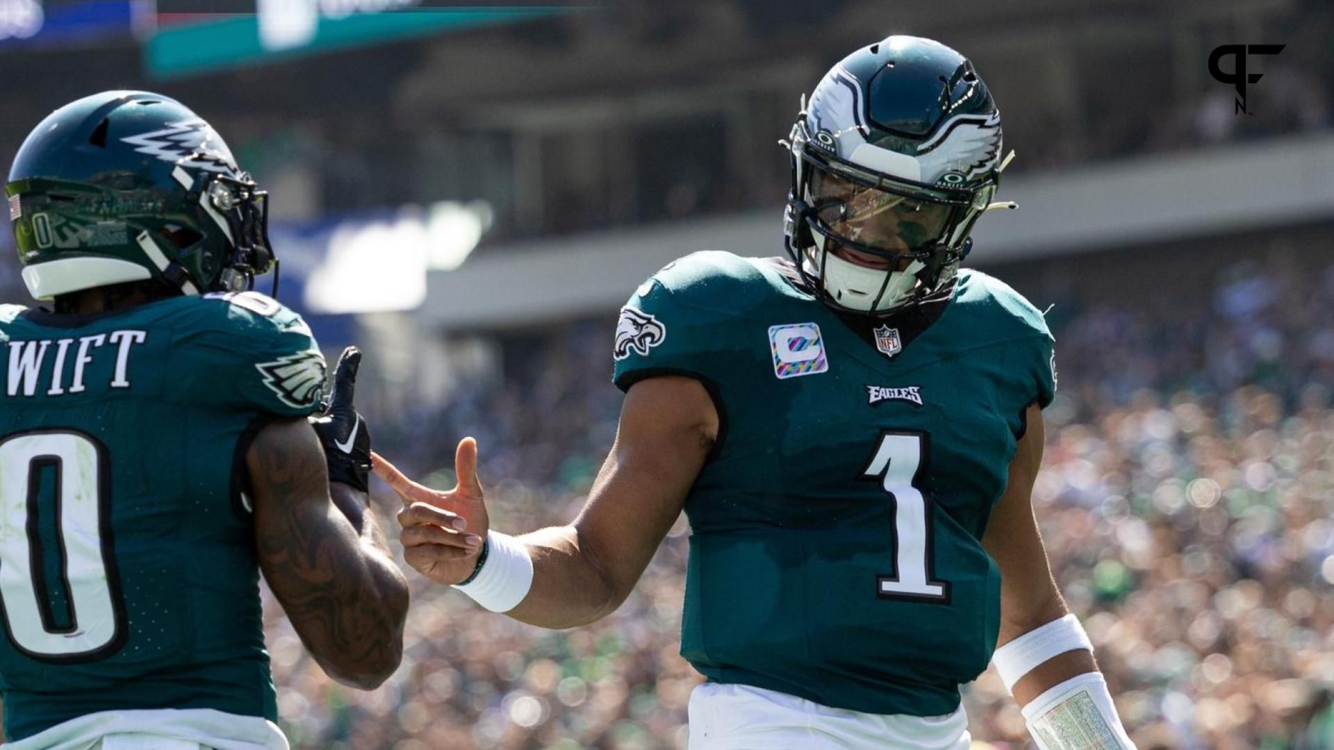 Philadelphia Eagles running back D'Andre Swift (0) celebrates with quarterback Jalen Hurts (1) after his touchdown run against the Washington Commanders during the first quarter at Lincoln Financial Field.