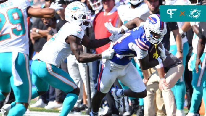 Buffalo Bills wide receiver Stefon Diggs (14) breaks a tackle by Miami Dolphins cornerback Kader Kohou (4) to score a touchdown in the second quarter at Highmark Stadium.